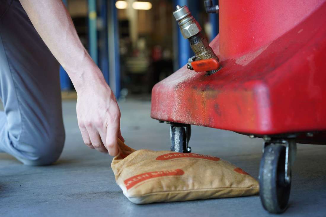 Green Boom pillow under a drum dispenser